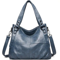 Hobo bleu jean délavé en cuir végan souple, anses rivetées et bandoulière amovible à mousquetons