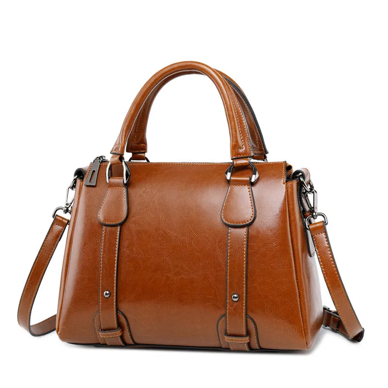 Marron caramel légèrement tourné, ce sac structuré montre ses surpiqûres et ses anses rondes