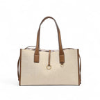 Cabas en toile de coton beige lin, anses et bordures en cuir végan caramel, présenté seul de face