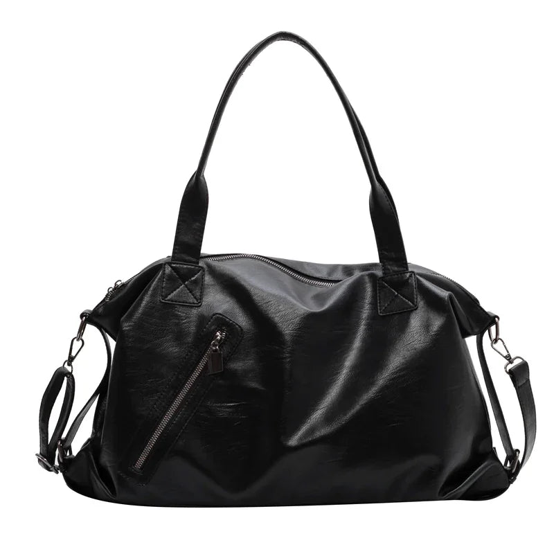 Grand sac polochon souple en cuir végan noir, anses courtes, bandoulière amovible et zip en biais