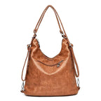 Dos du sac cognac, longue bandoulière réglable et poche zippée horizontale sur toute la largeur