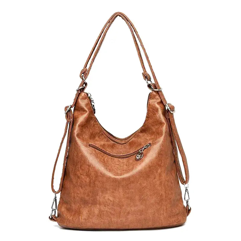 Dos du sac cognac, longue bandoulière réglable et poche zippée horizontale sur toute la largeur