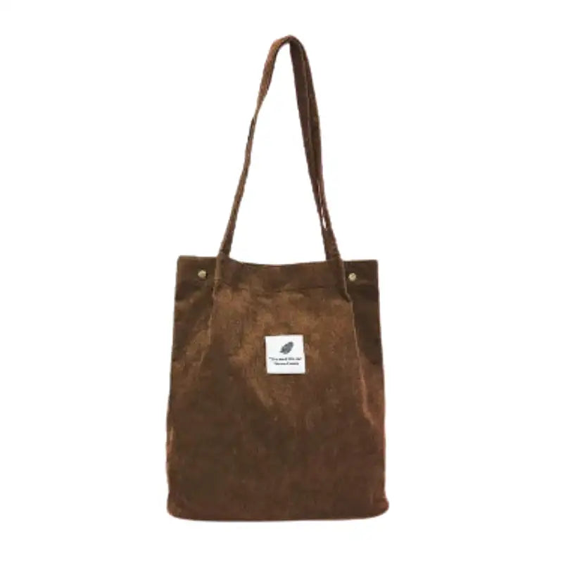 Tote bag en velours côtelé marron, vu de face, longues anses et étiquette brodée