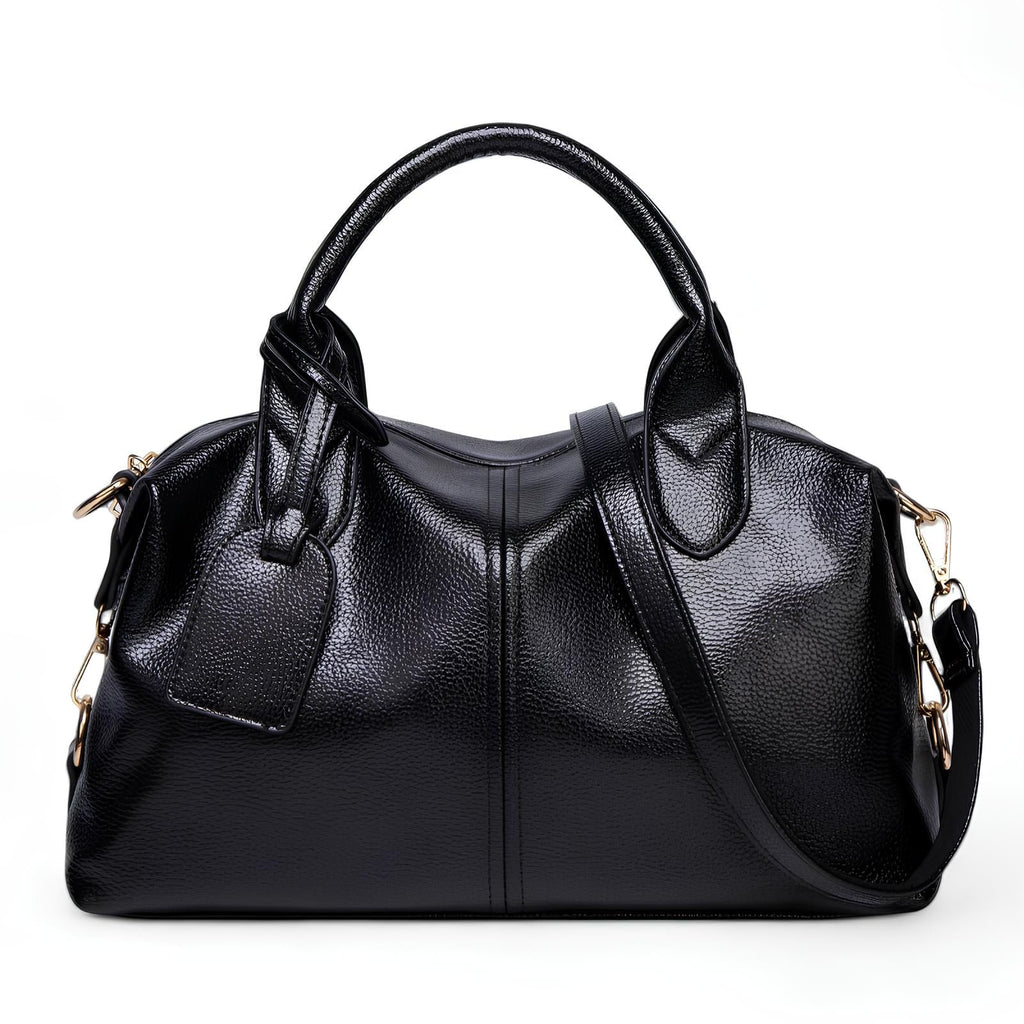 Bowling bag noir au grain souple, deux anses courtes, étiquette pendante et longue sangle amovible