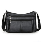 Petit sac bandoulière noir à double glissière, poche plaquée centrale et sangle large réglable