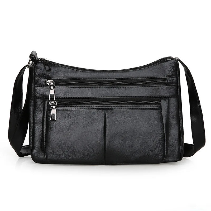 Petit sac bandoulière noir à double glissière, poche plaquée centrale et sangle large réglable