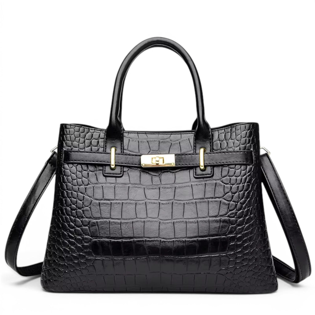 Sac à main structuré noir façon croco, de face, fermoir tournant doré et bandoulière fine