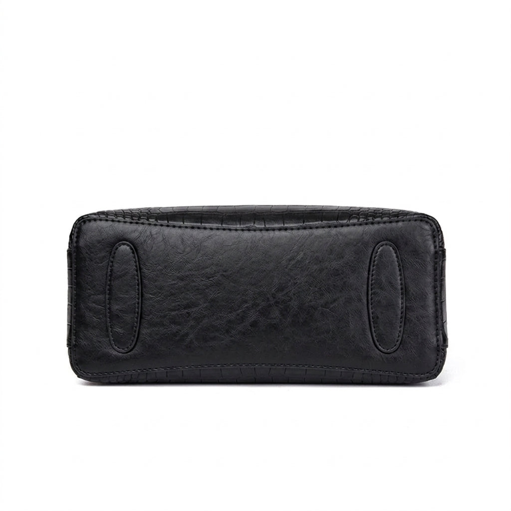 Fond plat du sac noir, patins de protection ovales et coutures de renfort apparentes