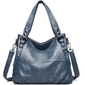 Hobo bleu jean délavé en cuir végan souple, anses rivetées et bandoulière amovible à mousquetons