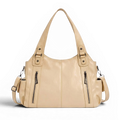 Hobo beige clair à deux poches zippées frontales, anse d'épaule souple, posé de face