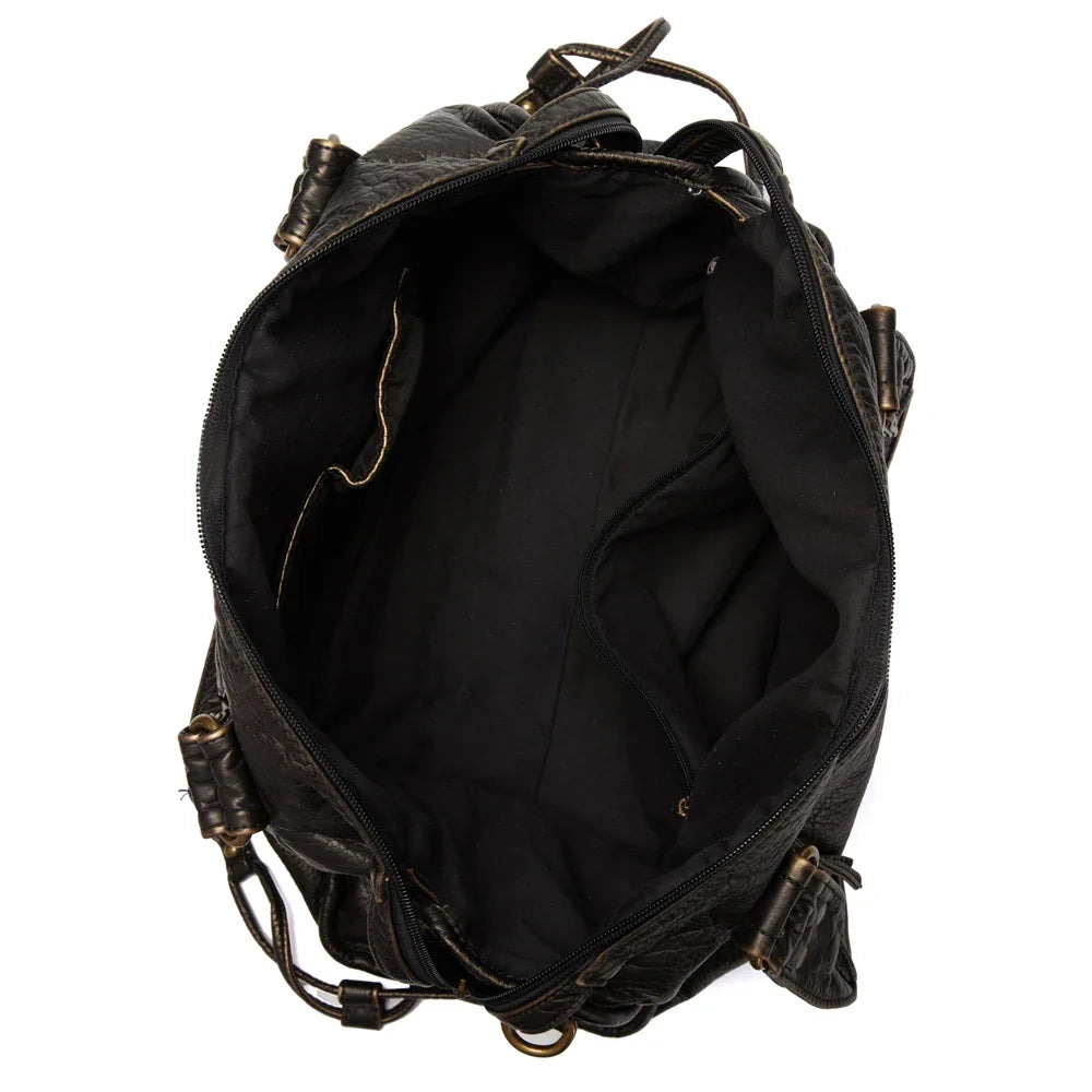 Intérieur textile noir vu de dessus, poche zippée sur la paroi et large ouverture entre les anses