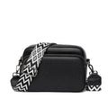 Petite besace zippée noire au grain fin, large bandoulière à chevrons noirs et blancs