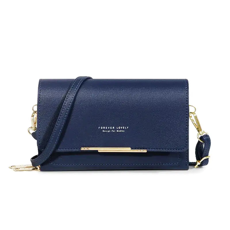 Bleu marine satiné pour ce sac bandoulière plat à rabat, barrette dorée et anse fine réglable