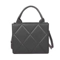 Sac à main noir matelassé en larges losanges, anse rigide et bandoulière fine, vu de face