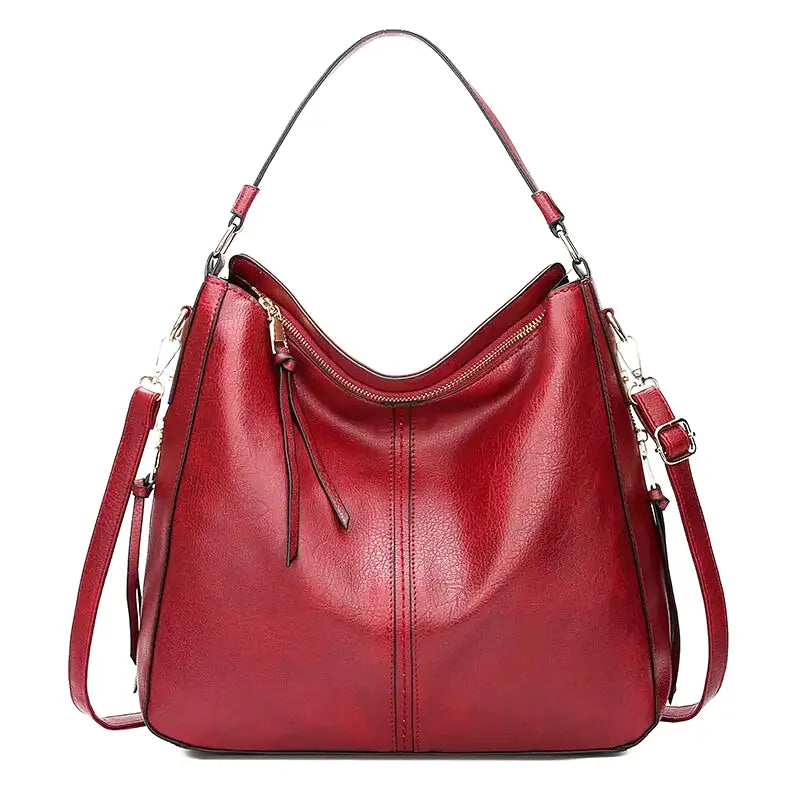 Rouge profond nuancé pour le même hobo, tirette zippée pendante et anse d'épaule rigide