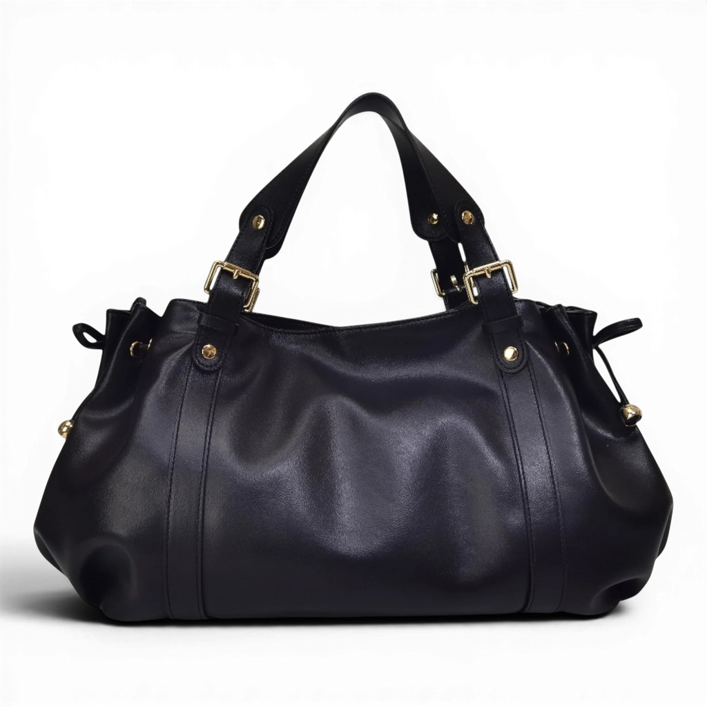 Silhouette froncée du sac noir sur fond sombre, anses doubles à boucles dorées et liens latéraux
