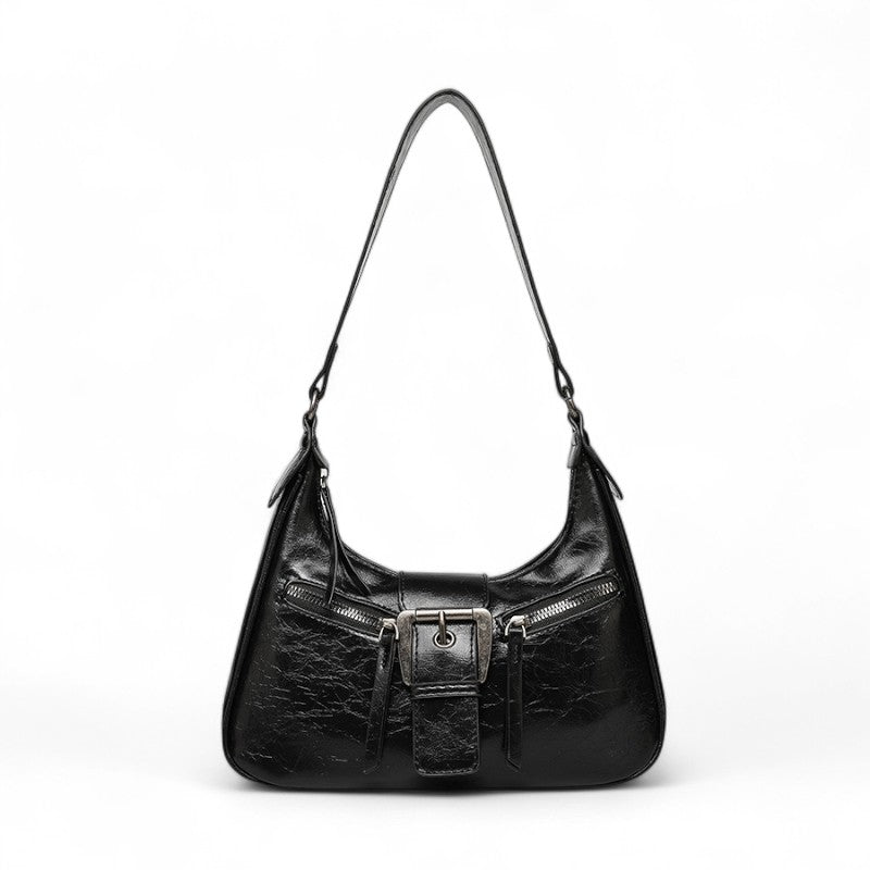 Noir brillant légèrement froissé, le même sac croissant vu de face, anse courte et zips