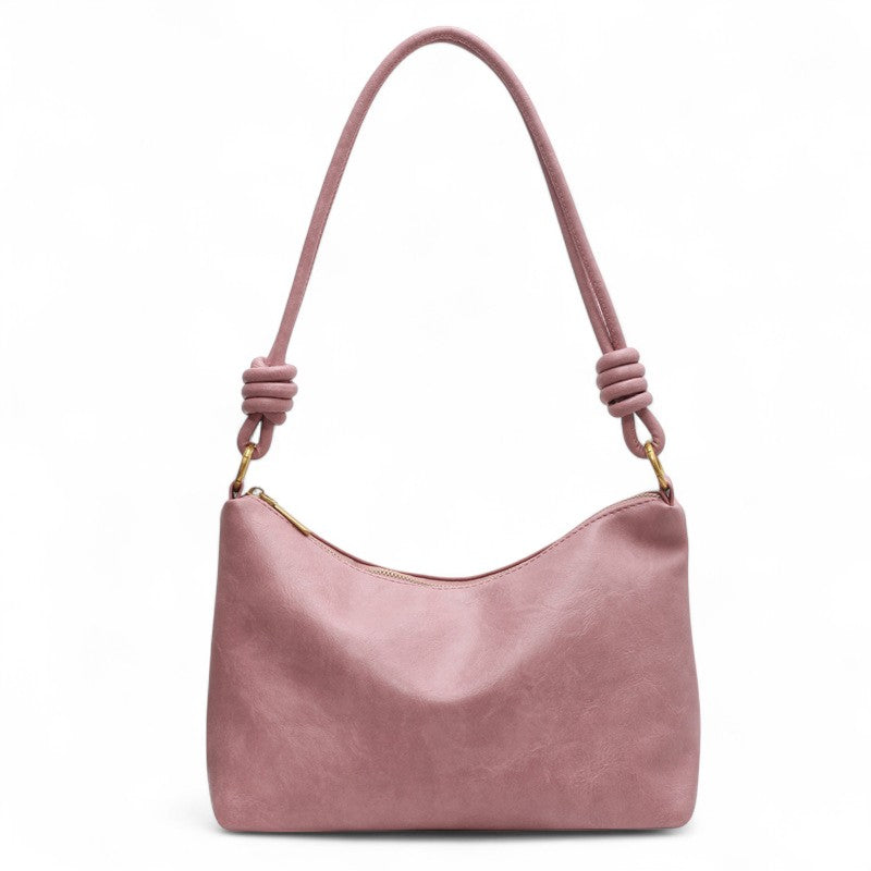 Rose poudré vieilli, ce sac d'épaule souple est vu de face, anse nouée et attaches dorées