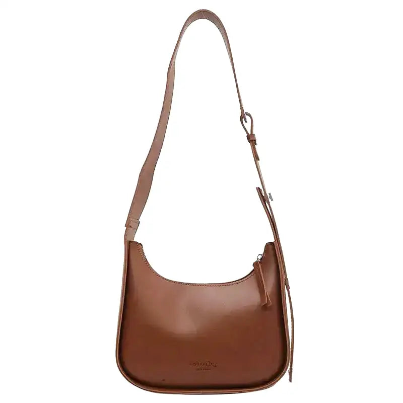 Besace cognac à ligne arrondie, bandoulière réglable et fermeture zippée sur le dessus
