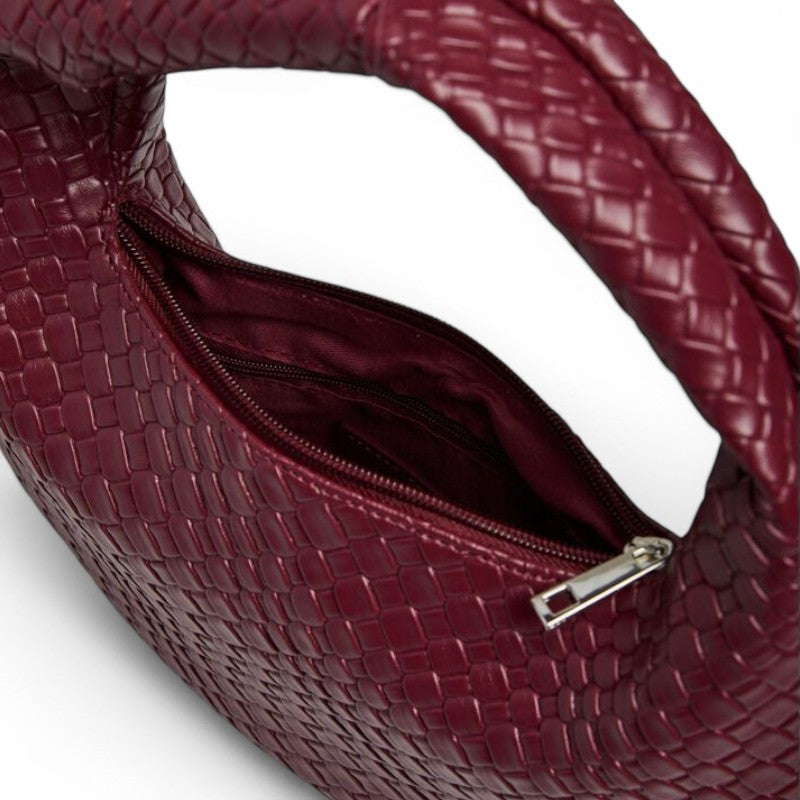 Ouverture zippée du hobo rouge sombre, doublure textile assortie et tirette argentée en gros plan
